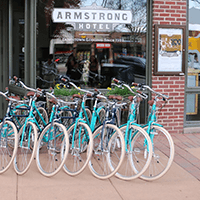 Row of blue bicycles outside Armstrong Hotel