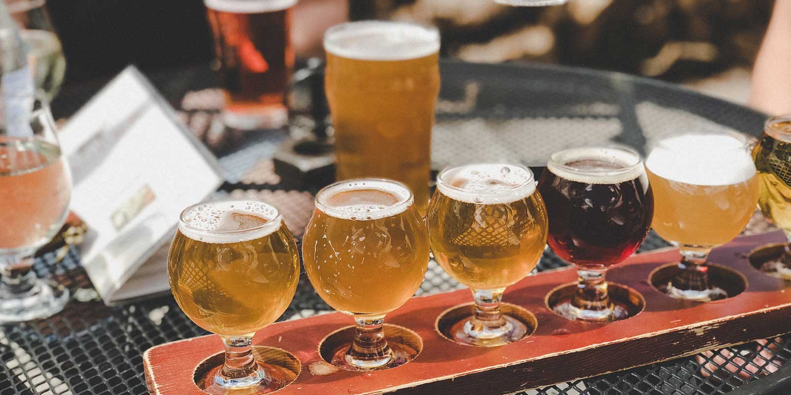 Flight of craft beers in pilsner glasses