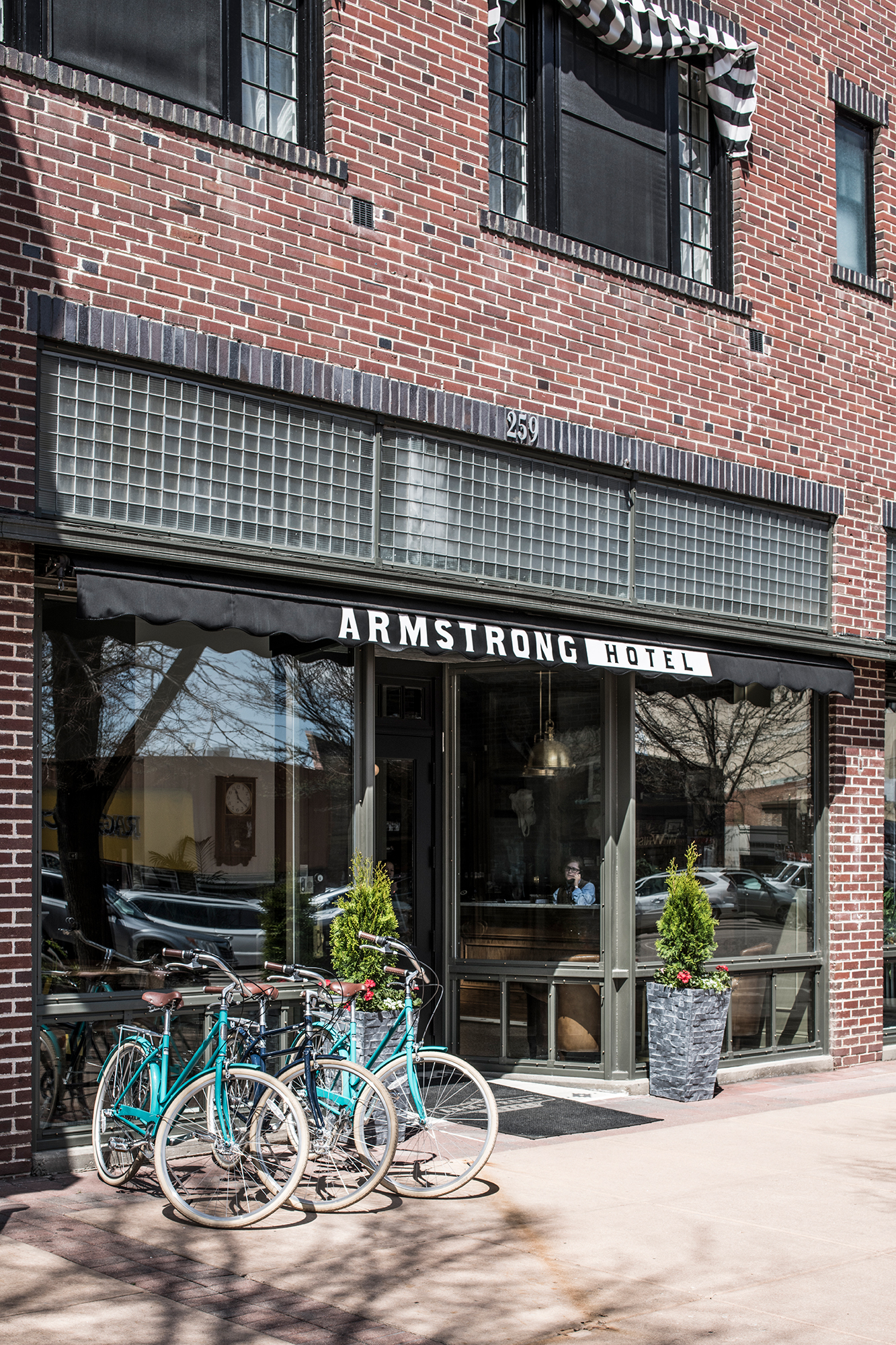 Front entrance of Armstrong Hotel with teal colored bikes 
