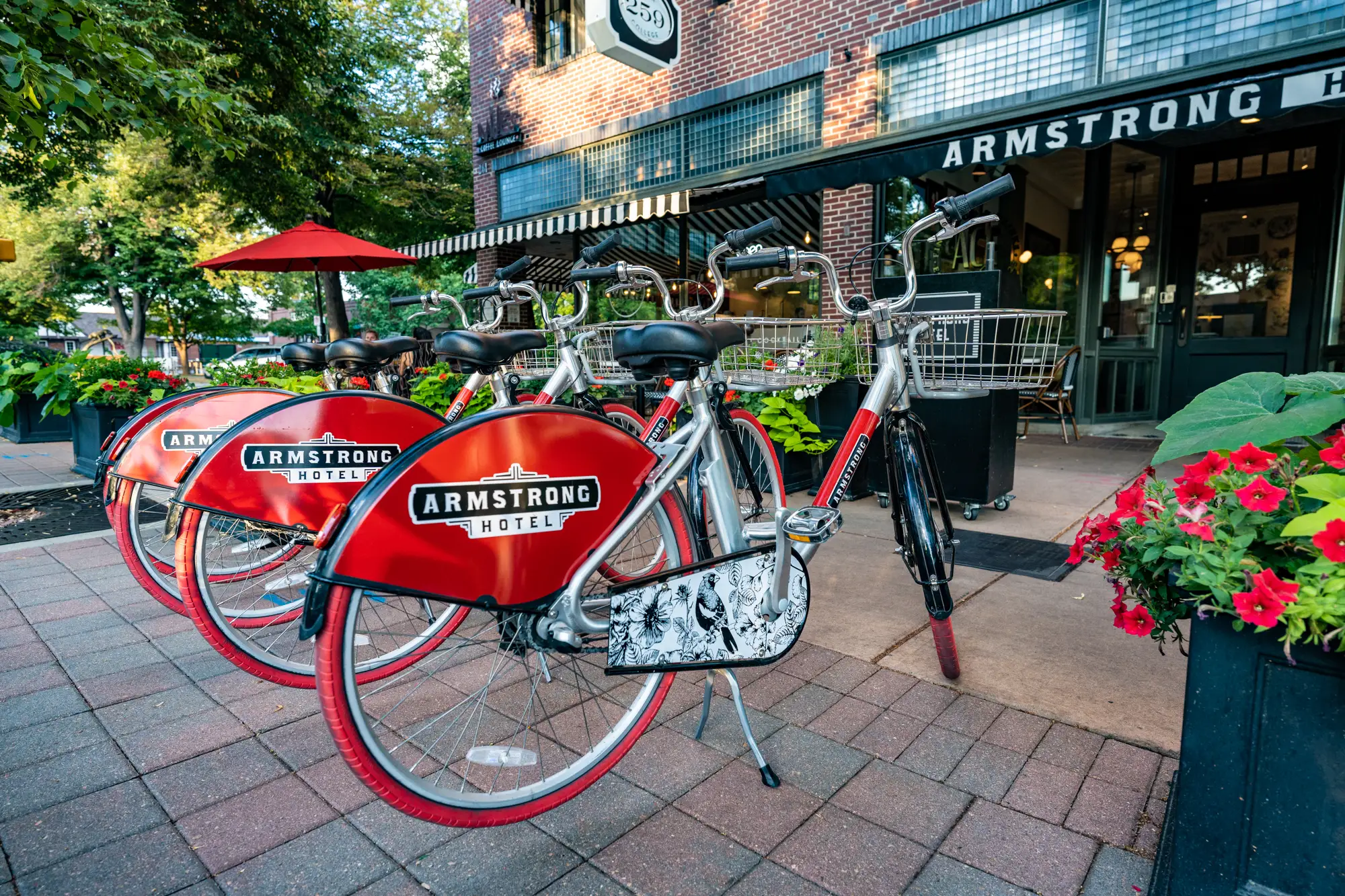 Red rental bikes outside Armstrong Hotel entrance